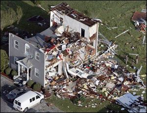 Residents and rescue personnel survey damage to an antiques store in Driver, Va. Six tornadoes roared through Virginia on Monday, injuring 200. All of the victims are expected to survive.