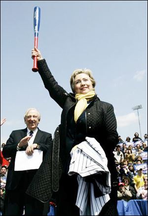 Democratic presidential hopeful Sen. Hillary Rodham Clinton, D-N.Y., holds up a bat she received as a gift during a rally at the Cove Ballpark in South Bend, Ind. Saturday, April 26, 2008. Former Congressman John Brademus applauds at left.