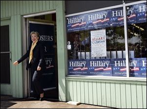 Democratic presidential hopeful, Sen. Hillary Rodham Clinton, D-N.Y., emerges from her campaign headquarters in South Bend, Ind., on Sunday to speak to campaign canvassers. 