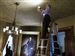 Albert Albano, executive director of the Cleveland-based Intermuseum Conservation Association, and Emily Helwig, a paper conservator, examine the drawing room ceiling.