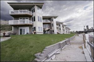Only seven condominiums have been built along Miami Street. The remaining lots sit undeveloped because of what the developer last week described as Toledo's slow housing market. The unfinished project has flirted with insolvency and required financial help from Neighborhood Housing Services.