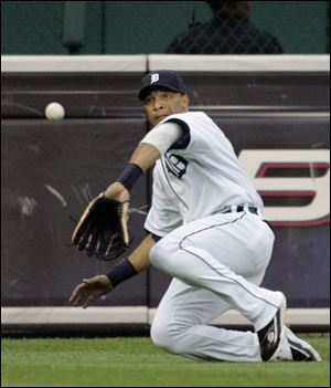 Tigers left fielder Gary Sheffield slides to make a catch on ball hit by the Yankees' Chad Moeller in the third inning.