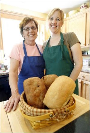Janice Hart, left, and daughter Heidi Grimsey with some of the bread they sell at the Adrian farmer's market.