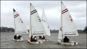 A team of three boats from Ohio State University competes in the Owens Team Race Invitational. Eight teams attended the event, held yesterday on the Ottawa River near the Jolly Roger Sailing Club. Inclement weather forced the event to drop the number of heats from 28 to 18.  
