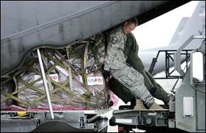Master Sgt. Todd Kneisley, a 1992 graduate of Defiance High School, helps crewmen load relief supplies for Myanmar on a C-130 cargo plane at Utapao Air Base in Thailand. The supplies will be flown to neighboring Myanmar, which was devastated by a cyclone more than a week ago. Sergeant Kneisley, an aerial porter, lives in Guam with his wife and two children, Dan Kneisley, his father, a Defiance resident, said. 