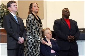 Attorney Thomas Sobecki, left, Crystal Dixon, her mom Nadine Dixon and church Bishop James M. Williams, Sr., gather at a press conference and support rally at End Time Christian Fellowship, in Toledo on Wednesday.