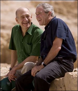 U.S. President George W. Bush, right, and Israeli Prime Minister Ehud Olmert share a laugh after touring the historic fortress of Masada, Thursday, in Israel. The leaders toured Masada, the ancient fortress on a plateau in the desert overlooking the Dead Sea, said to be the place where Jewish rebels killed themselves and each other 2,000-years ago rather than fall into slavery under the Romans. 