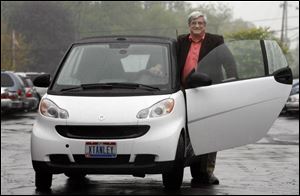 Stan Rubini helps keep down the cost of driving with his Smartfortwo, an import that delivers an estimated 32 miles per gallon. Other fuel-efficient models such as the Toyota Prius, Ford Focus, Honda Fit, and Chevrolet Aveo are rising in popularity as gasoline hovers at just under $4 a gallon. A drawback, Mr. Rubini says: 'People asking me questions' about the car.