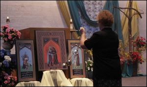 Sister Diana Lynn Eckel uses incense in blessing an icon, a triptych depicting St. Francis of Assisi's 1219 visit to Egypt, in an installation ceremony at the Sisters of St. Francis chapel.