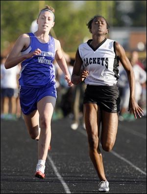 Perrysburg's Cameron Gardner, right, nips defending league champ Erika Schmidt of Anthony Wayne at the finish of the 100-meter dash. She finished in 12.29 seconds.