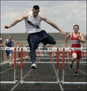 Lakota's Justin Apple clears a hurdle on the way to victory in the 300-meter hurdles. 