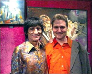 Rolling Stones guitarist Ron Wood, left, with Tim Ries at a showing of Wood's art.