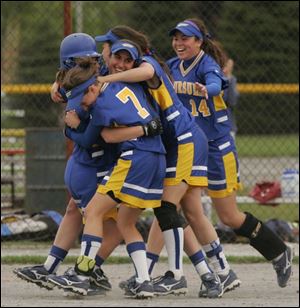Tori Allen (in helmet), is mobbed by St. Ursula teammates Lauren Grana (7), Ana Dreeze (facing camera), Caitlin Jadwisiak and Chelsey Arnett (14) after she drove in the winning run in the district title game. (BLADE PHOTOS/JETTA FRASER)
<br>
<img src=http://www.toledoblade.com/graphics/icons/video.gif> <b><font color=red>VIEW</b></font color=red>: <a href=
