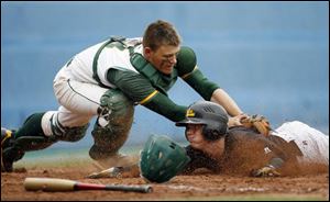 Start catcher Joe Maurer tags out Northview s Zach Ryder to end the fourth inning in yesterday s
Division I baseball district championship at Skeldon Stadium.