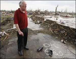 Dennis Schipper looks over his flattened home after a powerful storm ripped through the town of Parkersburg, Iowa, Sunday.