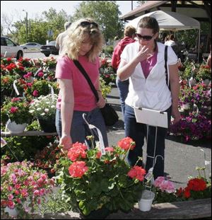 Mary Weirich and daughter Sherry, both of Toledo, browse plants available from dozens of area vendors.