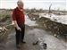 Dennis Schipper looks over his flattened home after a powerful storm ripped through the town of Parkersburg, Iowa, Sunday.