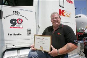 Ronald Hawkins Jr. of Perrysburg Township shows off the lettering on his rig that recognizes him as the Ohio Trucking Association's driver of the year. He has 24 years in the field.