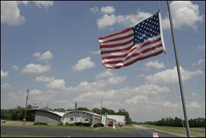 The flag flies at half staff outside Fremont Airport yesterday in memory of Gene Damschroder and his five passengers. Yesterday there was speculation the pilot knew he was going to crash and tried to land in the only clearing available nearby.
