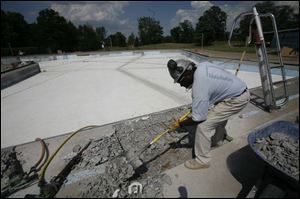 Victor Covington prepares the Detwiler pool. A city spokesman says it will open in June. (THE BLADE/HERRAL LONG)
<br>
<img src=http://www.toledoblade.com/assets/gif/weblink_icon.gif> <font color=red> <b>CITY OF TOLEDO</font color=red></b>: <a href=