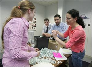 New central committee Chairman Meghan Gallagher, left,
Chris Mueller, Constantine Stamos, and Kelly Bensman examine shredded documents found in the party headquarters.