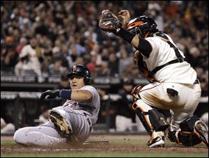 Detroit Tigers' Miguel Cabrera, left, is tagged out at home plate by San Francisco Giants catcher Bengie Molina during the seventh inning Tuesday, in San Francisco. Cabrera attempted to score on a single by Ivan Rodriguez.