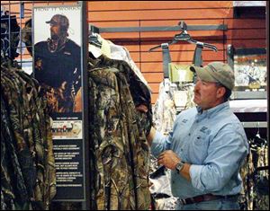 Matt Johnson of Ashland, Ohio, examines hunting apparel at the new outdoors retailer, the second one in Ohio. (THE BLADE/AMY E. VOIGT)
<br>
<img src=http://www.toledoblade.com/graphics/icons/photo.gif> <font color=red><b>VIEW</font color=red></b>: <a href=