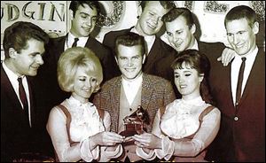 Randy Sparks, center, and the New Christy Minstrels celebrate
their Grammy for top album in 1962.