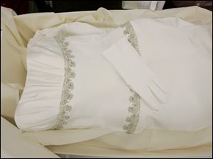 White gloves are left on a preserved and boxed wedding dress at Hallak Cleaners Friday, May 30, 2008, in Hackensack, N.J. The gloves are left in case the owner might want to handle the dress. 
<br>
<img src=http://www.toledoblade.com/graphics/icons/video.gif> <b><font color=red>VIDEO</b></font color=red>: <a href=" http://video.ap.org/vws/search/aspx/ap.aspx?t=s1179103307915&p=ENAPoffbeat_ENAPoffbeat&g=0619dv_toilet_paper_dress&f=OHTOL" target="_blank "><b>Toilet Paper Wedding Dresses Not for Flushing</b></a>