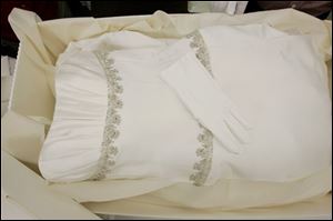 White gloves are left on a preserved and boxed wedding dress at Hallak Cleaners Friday, May 30, 2008, in Hackensack, N.J. The gloves are left in case the owner might want to handle the dress. 
<br>
<img src=http://www.toledoblade.com/graphics/icons/video.gif> <b><font color=red>VIDEO</b></font color=red>: <a href=