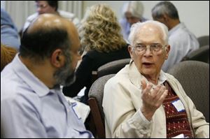 S. Zaheer Hasan, left, a Muslim, talks with Bill Searles, a Unitarian, at the discussion sponsored by WGTE-TV, Channel 30, and the MultiFaith Council of Northwest Ohio.