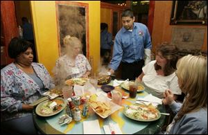 Jorge Hernandez serves Allegra Nunn, left, Patti Schlegel, Tammy Kruger, and Mindy Castle at El Camino at Sylvania Ave. and Douglas Rd.