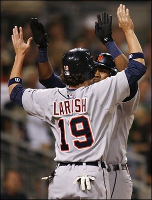 Detroit Tigers' Marcus Thames, rear, is congratulated by teammate Jeff Larish (19) after hitting a two-run homer hit off of San Diego Padres pitcher Justin Hampson during the seventh inning of a baseball game Saturday, June 21, 2008, in San Diego. The Tigers won 7-5. 