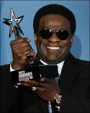 Al Green poses with his BET's Lifetime Achievement Award backstage at the BET Awards on Tuesday in Los Angeles. 