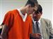 Corey S. Flugga, 22, consults with attorney Ken Sass during an extradition hearing in Findlay yesterday. 