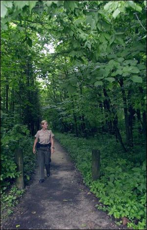 Park employee Jamie Murphy walks along one of three hiking trails at Goll Woods State Nature Preserve in 2001.
