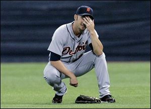 Tigers right fielder Ryan Raburn can't believe the umpires ruled his attempt to make a diving catch in the sixth a trap. 