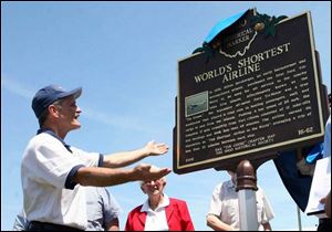 Dave Hirt, local secretary of the Experimental Aircraft Association, marvels at the newly unveiled historical marker at the airport. The group's 1929 Tri-Motor was rebuilt over a 12-year period and is flown on tours.