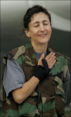 Former hostage Ingrid Betancourt gestures as she arrives to a military base in Bogota after being rescued from six years of captivity on Wednesday. 