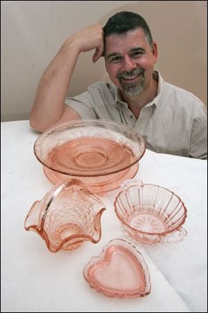 Michael Catanzaro with a few pieces of his mother's pink Depression glassware that he inherited in 2007.