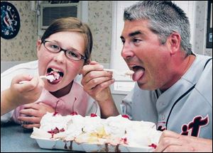 Erin Snyder and her dad, Tim, eat a Banana Trough Sundae built by the team at Shubie s Ice Cream and Grill.