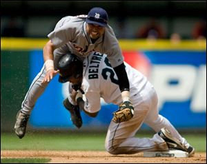 The Tigers' Placido Polanco gets taken out by Adrian Beltre while trying to turn a double play in the seventh inning.