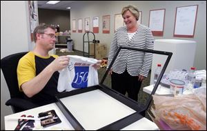 Davis College marketing assistant Brian Houdashelt shows Diane Brunner, the college president, his preparations for tomorrow's 150th anniversary events in the college's new Heritage Museum. Among its relics are an array of old typewriters. 