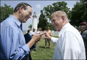 Former Ohio Gov. Bob Taft and present Gov. Ted Strickland joke before the ceremonial signing at Marblehead Lighthouse.