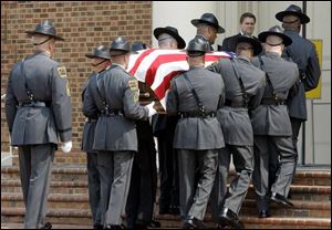 Troopers carry the casket of former Sen. Jesse Helms into Hayes-Barton Baptist Church. Vice President Dick Cheney and North Carolina Gov. Mike Easley were among the mourners.
