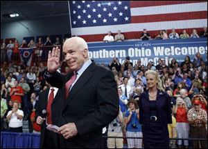 Republican presidential candidate John McCain, with his wife, Cindy, right, greets supporters during a campaign stop at the Portsmouth High School gym in southern Ohio.