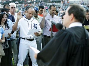 Tigers second baseman Placido Polanco and 99 others are
sworn in as citizens before last night s game in Detroit.
