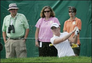 Toledo native Stacy Lewis intently watches her ball from a sand trap on No. 9 in the opening round. She shot a 1-under 70.