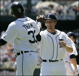 Clete Thomas, right, hit his first major league home run, a tworun-shot, and is congratulated by Marcus Thames.