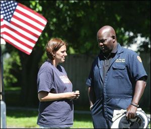 Heidi Dolaney talks with State Fire Marshal Michael Bell. Ms. Dolaney s father, Jimmy White, was one of two men who died in the large, intense early morning blaze.
